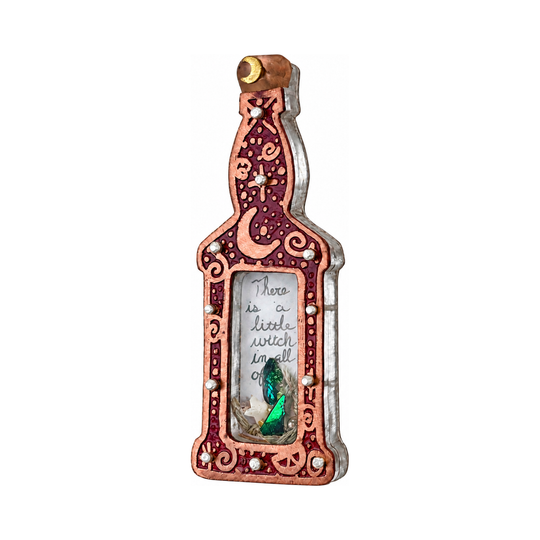 Red potion bottle pin shown from the right, with the handwritten note and green crystal visible through the window